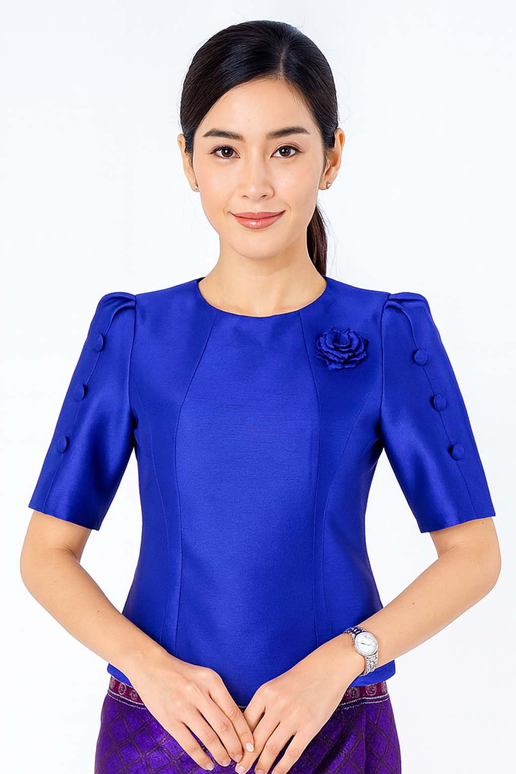 Ladies authentic Thai silk blouse for women with elegant half sleeves, round neckline, decorative fabric-covered buttons, floral brooch detail and a tailored fitted silhouette. Paired with a traditional Thai patterned sarong skirt, this classic Thai formal outfit is perfect for weddings, temple visits, cultural ceremonies, festivals, receptions and special occasions. Amazon Etsy eBay Siam Regal