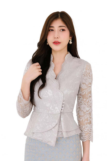 Ladies authentic Thai lace blouse for women featuring elegant floral lace, long sleeves, scalloped high neckline, wrap-style design, decorative fabric-covered buttons, peplum waist and tailored fitted silhouette. Paired with a traditional Thai patterned sarong skirt, this classic Thai outfit is perfect for weddings, temple visits, cultural ceremonies, festivals, formal events and special occasions. Amazon Etsy eBay Siam Regal