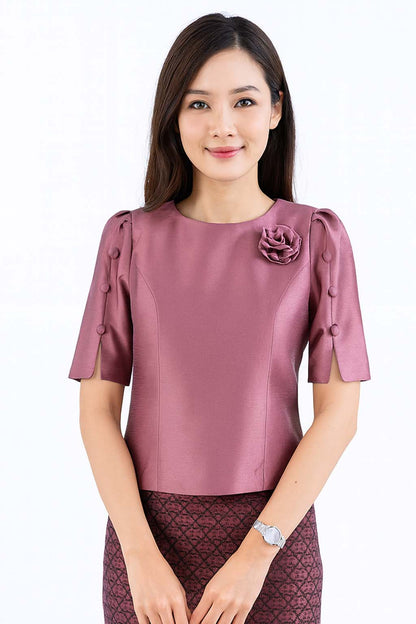 Ladies authentic Thai silk blouse for women with elegant half sleeves, round neckline, decorative fabric-covered buttons, floral brooch detail and a tailored fitted silhouette. Paired with a traditional Thai patterned sarong skirt, this classic Thai formal outfit is perfect for weddings, temple visits, cultural ceremonies, festivals, receptions and special occasions. Amazon Etsy eBay Siam Regal