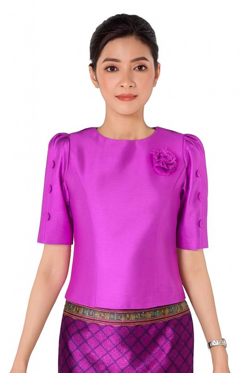 Ladies authentic Thai silk blouse for women with elegant half sleeves, round neckline, decorative fabric-covered buttons, floral brooch detail and a tailored fitted silhouette. Paired with a traditional Thai patterned sarong skirt, this classic Thai formal outfit is perfect for weddings, temple visits, cultural ceremonies, festivals, receptions and special occasions. Amazon Etsy eBay Siam Regal