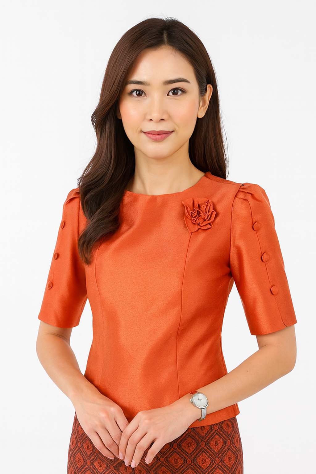 Ladies authentic Thai silk blouse for women with elegant half sleeves, round neckline, decorative fabric-covered buttons, floral brooch detail and a tailored fitted silhouette. Paired with a traditional Thai patterned sarong skirt, this classic Thai formal outfit is perfect for weddings, temple visits, cultural ceremonies, festivals, receptions and special occasions. Amazon Etsy eBay Siam Regal