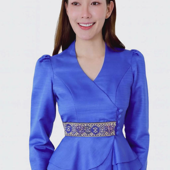 Ladies authentic Thai silk blouse for women with elegant long sleeves, V-neck wrap-style neckline, decorative fabric-covered buttons, traditional Thai woven waist trim and layered peplum hem. Tailored fitted silhouette inspired by classic Thai clothing, perfect for weddings, temple visits, cultural ceremonies, festivals, formal events and special occasions. Amazon Etsy eBay Siam Regal